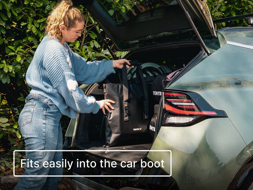 Person loading the TentBox CoolBag into the car boot with text 'Fits easily into the car boot'.