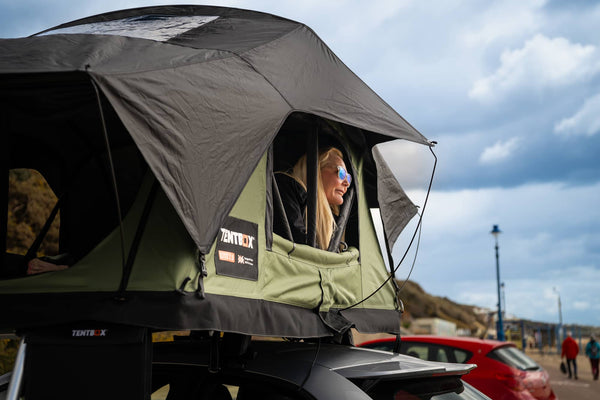 Woman looks out of her green TentBox Lite 2.0
