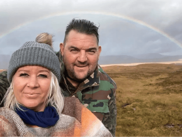 Couple posing whilst travelling with roof tent